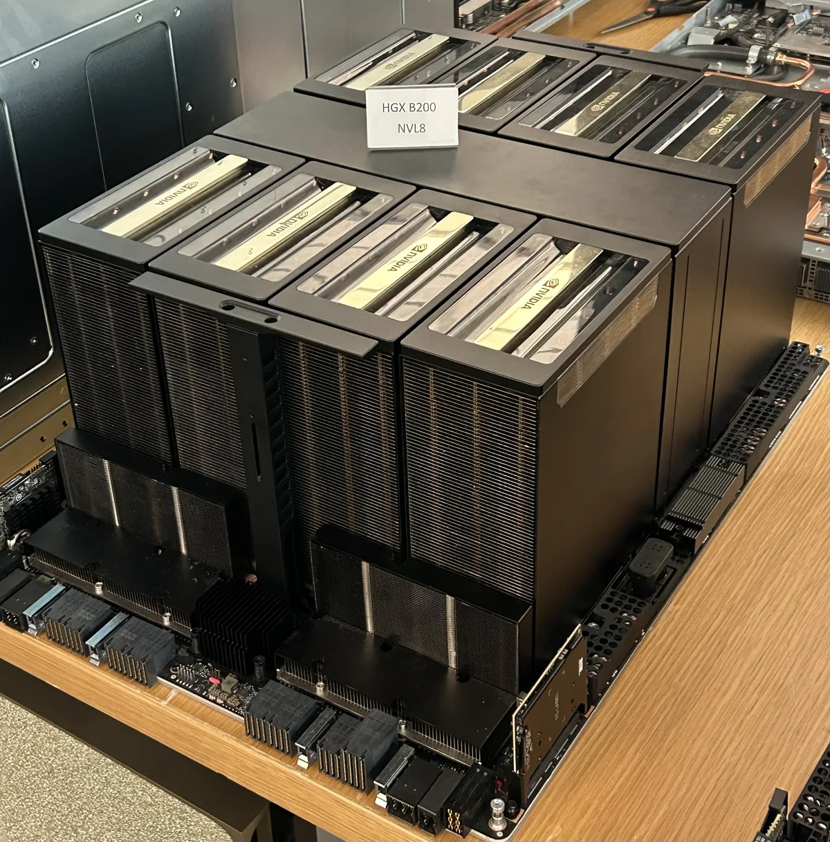 HGX B200 GPU board with eight large heatsinks on a display table