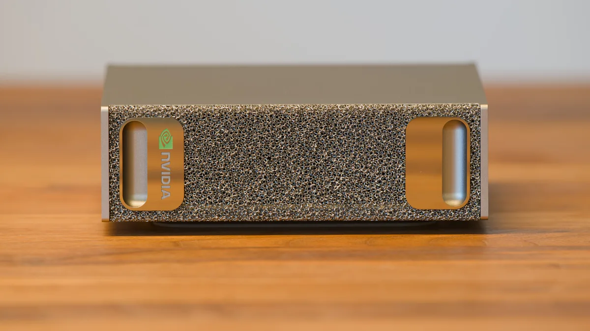 Front of a compact NVIDIA DGX Spark computer resting on a wooden surface