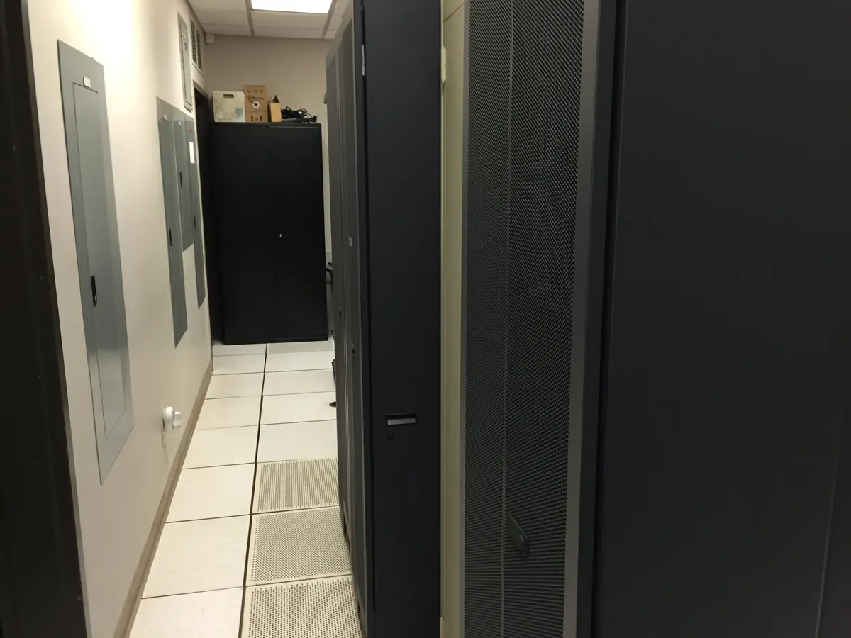 Black server cabinets beside a raised-floor aisle at the National Weather Service office in Elko, Nevada